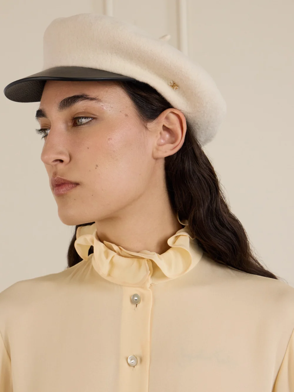 Valentino Garavani Embellished Leather-trimmed Wool Cap, styled view