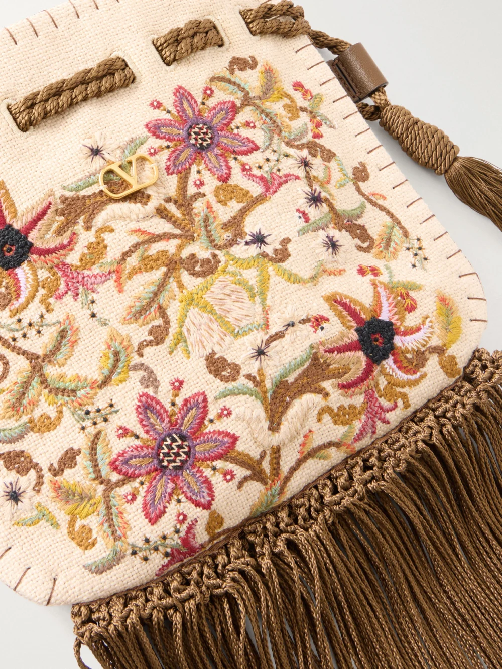 Close-up detail of the Valentino Garavani Embroidered Fringed Canvas Drawstring Shoulder Bag