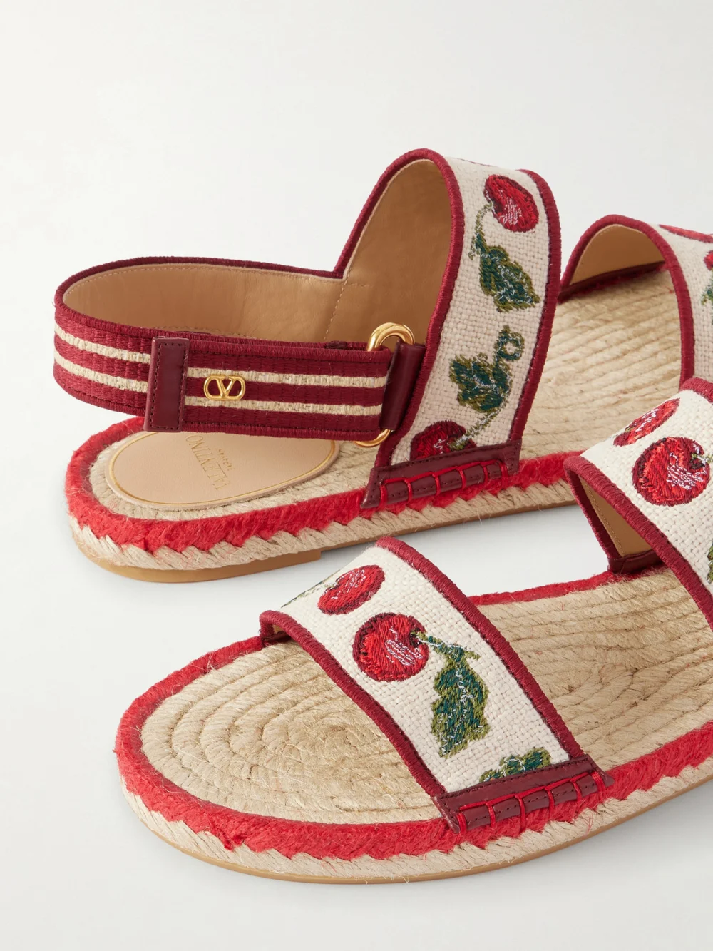 Close-up detail of the Valentino Garavani Embroidered Leather-trimmed Raffia Sandals