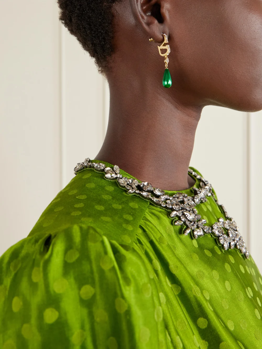 Close-up detail of the Valentino Garavani Gold-tone Beaded Crystal Earrings