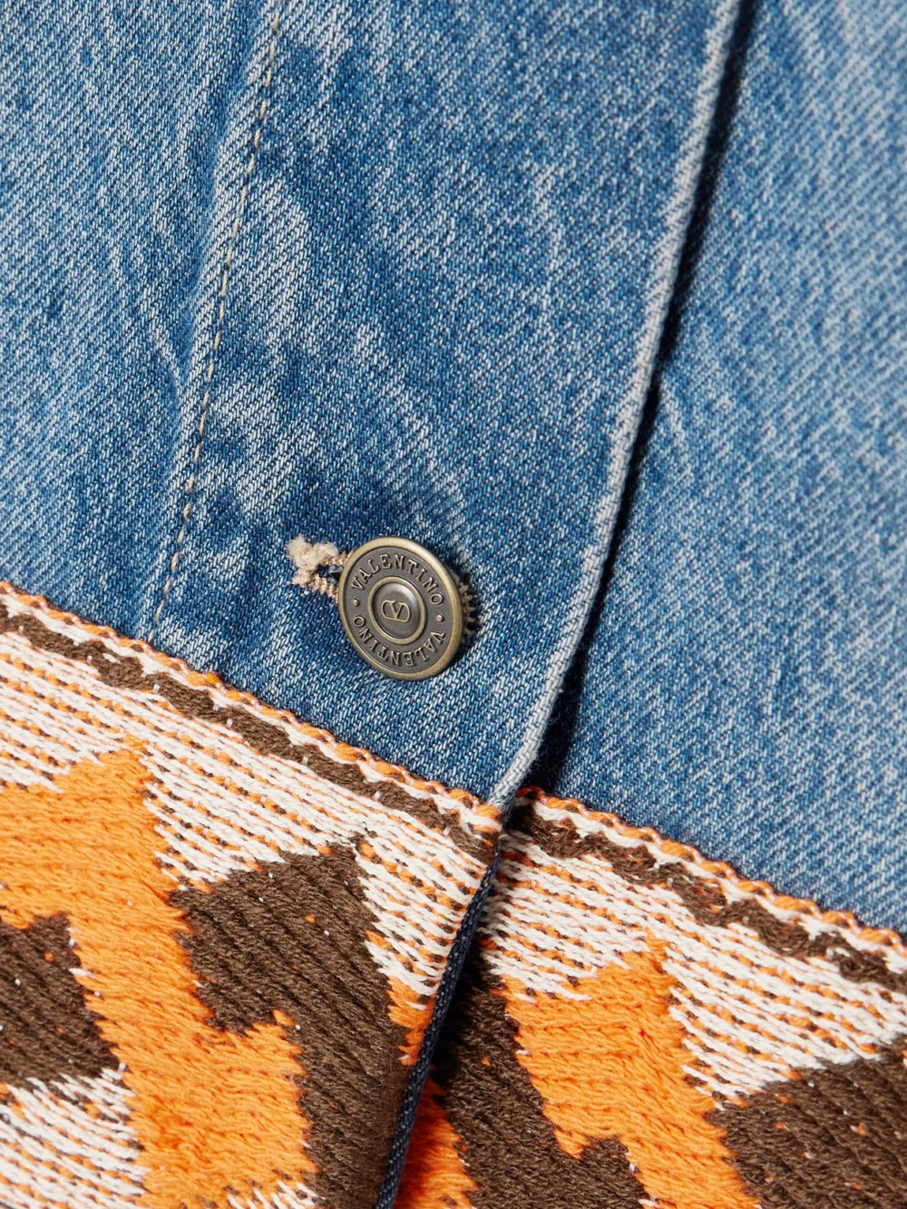Close-up detail of the Valentino Garavani Jacquard-trimmed Paneled Denim Mini Skirt