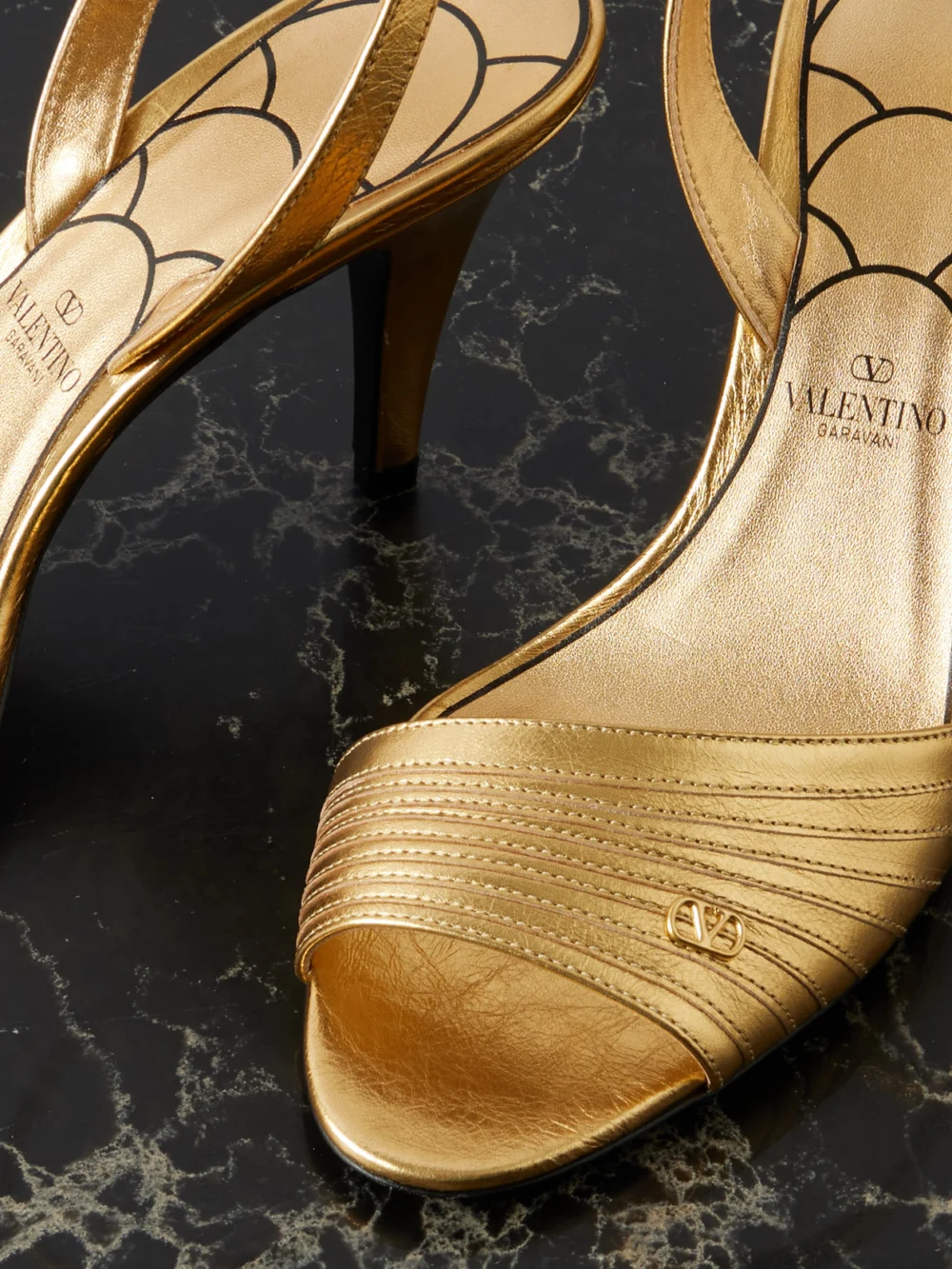Close-up detail of the Valentino Garavani Ladycrush 85 Embellished Metallic Leather Sandals
