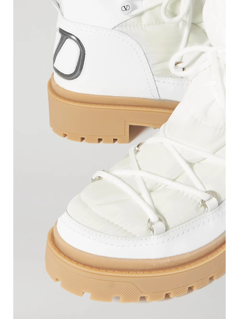 Close-up detail of the Valentino Garavani Logo-detailed Leather and Quilted Shell Ankle Boots