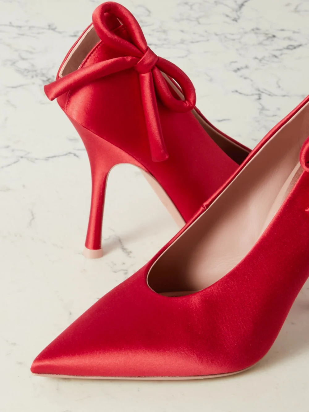 Close-up detail of the Valentino Garavani Nite-out 110 Bow-detailed Cutout Satin Pumps