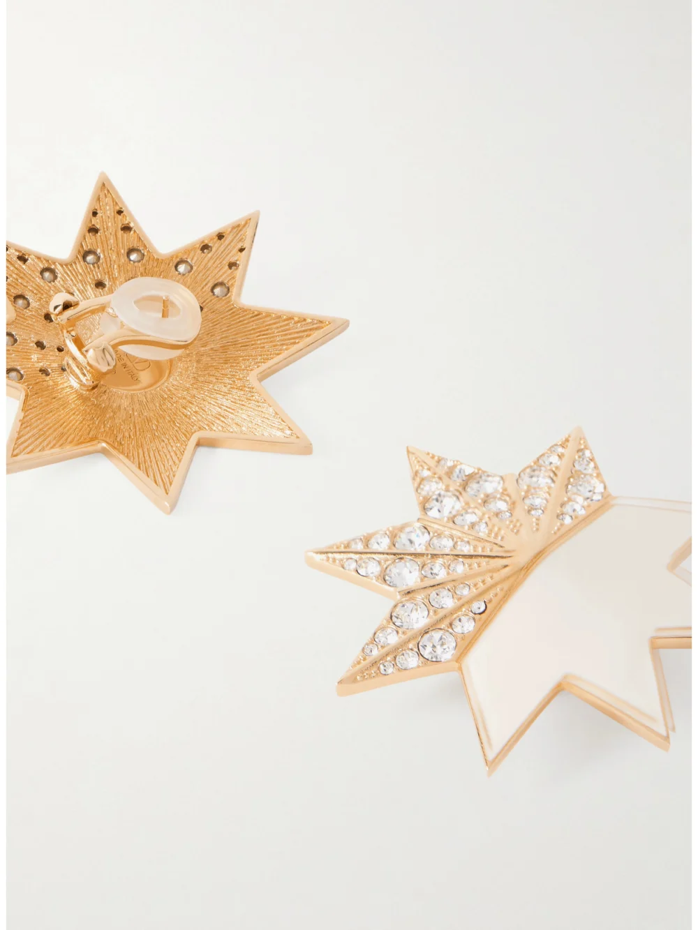 Close-up detail of the Valentino Garavani Pas Plus Gold-tone, Crystal and Enamel Clip Earrings