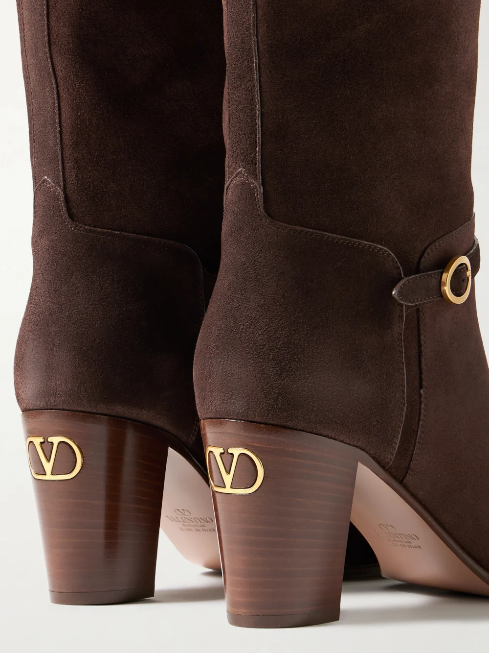 Close-up detail of the Valentino Garavani Pattie 75 Buckle-embellished Suede Knee Boots