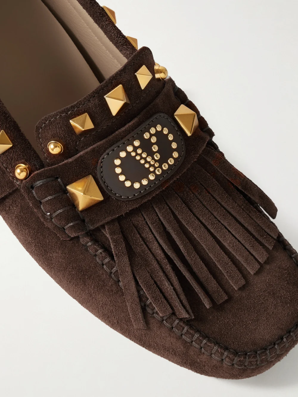 Close-up detail of the Valentino Garavani Plaster Caster Fringed Studded Suede Loafers