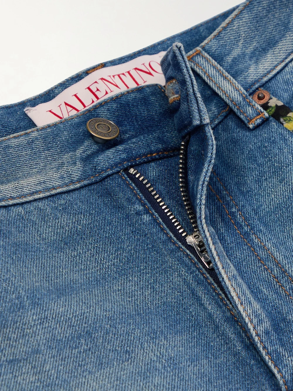 Close-up detail of the Valentino Garavani Printed Chiffon-trimmed High-rise Straight-leg Jeans