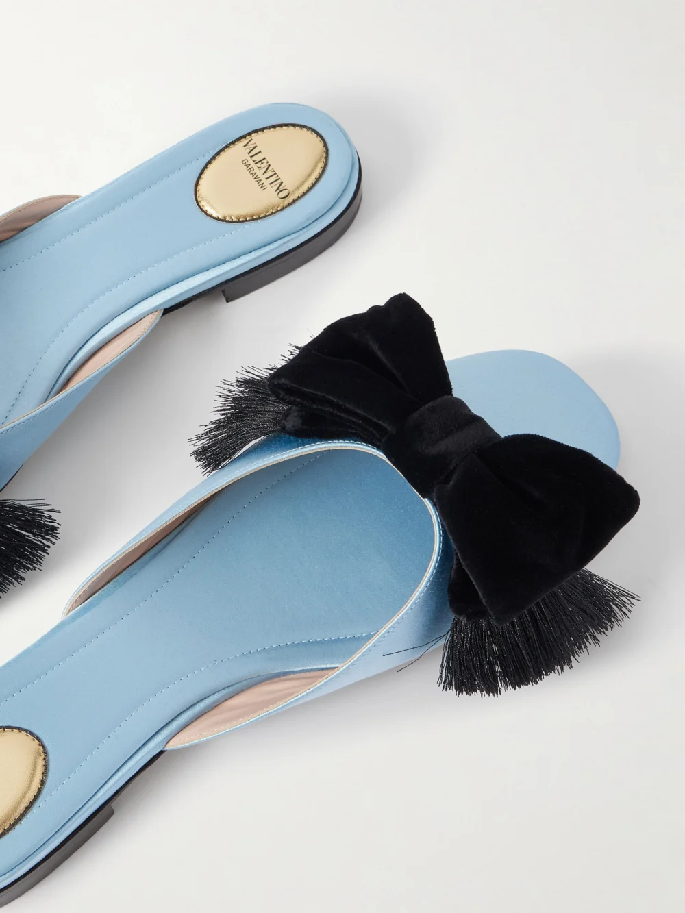 Close-up detail of the Valentino Garavani Reinette Bow-embellished Velvet-trimmed Satin Flats