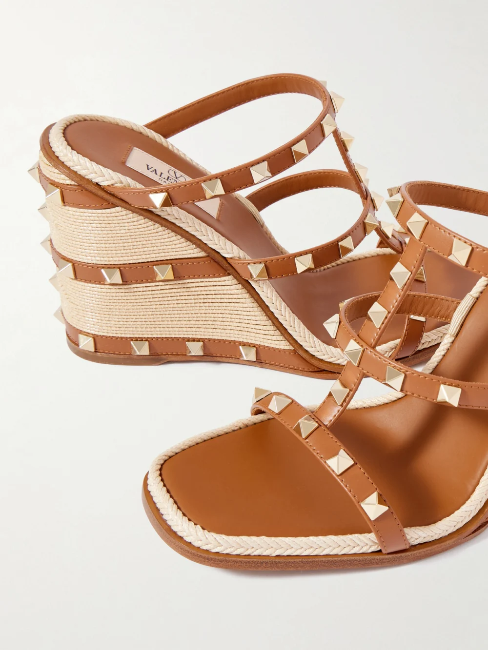 Close-up detail of the Valentino Garavani Rockstud 100 Leather Wedge Espadrille Sandals