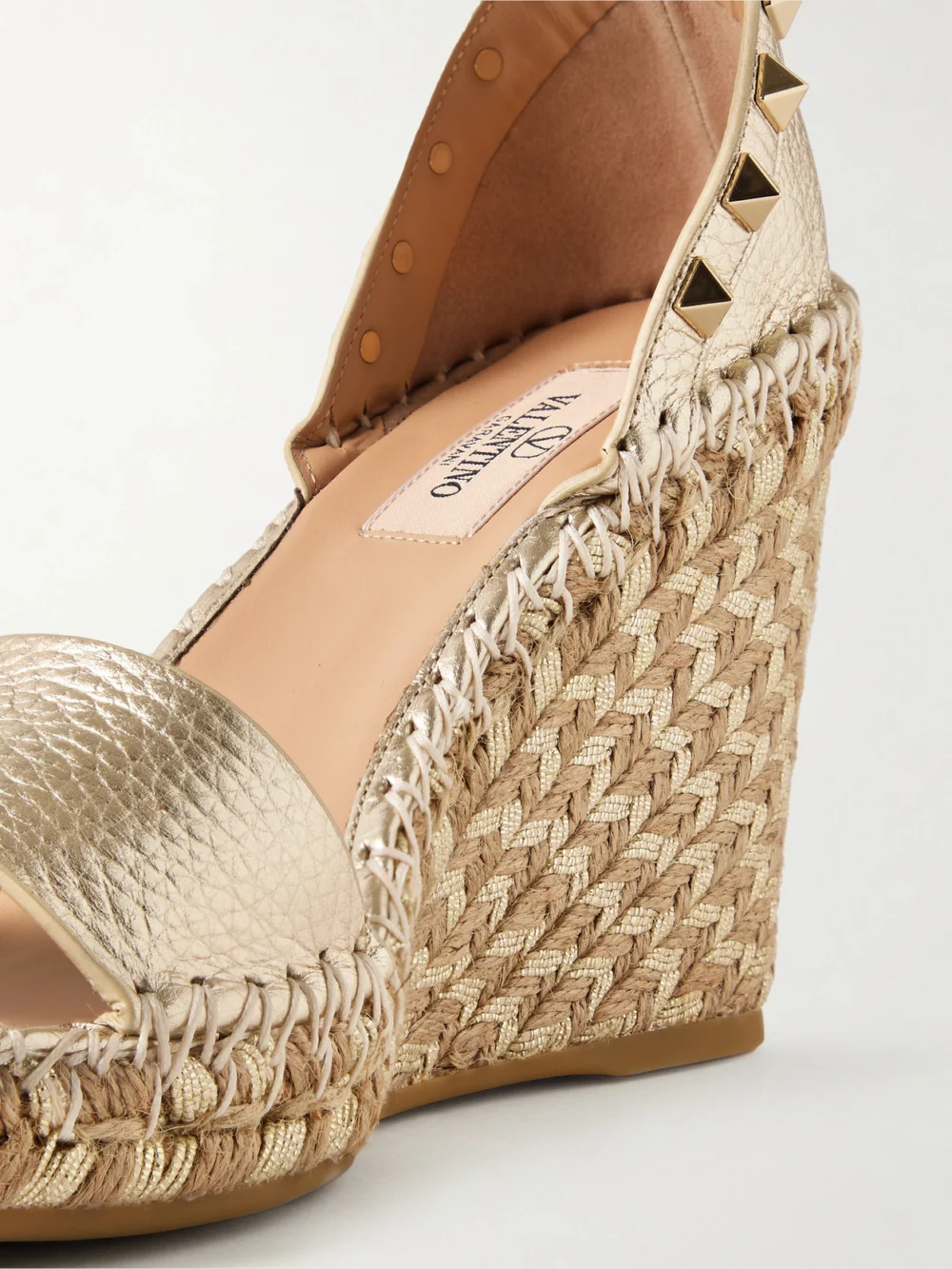 Close-up detail of the Valentino Garavani Rockstud 105 Metallic Textured-leather Espadrille Wedge Sandals