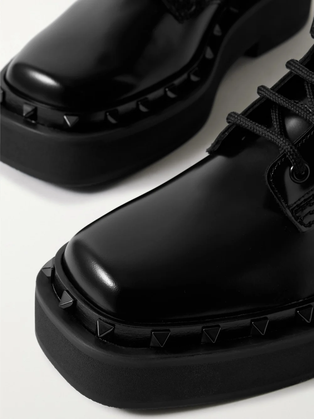 Close-up detail of the Valentino Garavani Rockstud Embellished Glossed-leather Ankle Boots