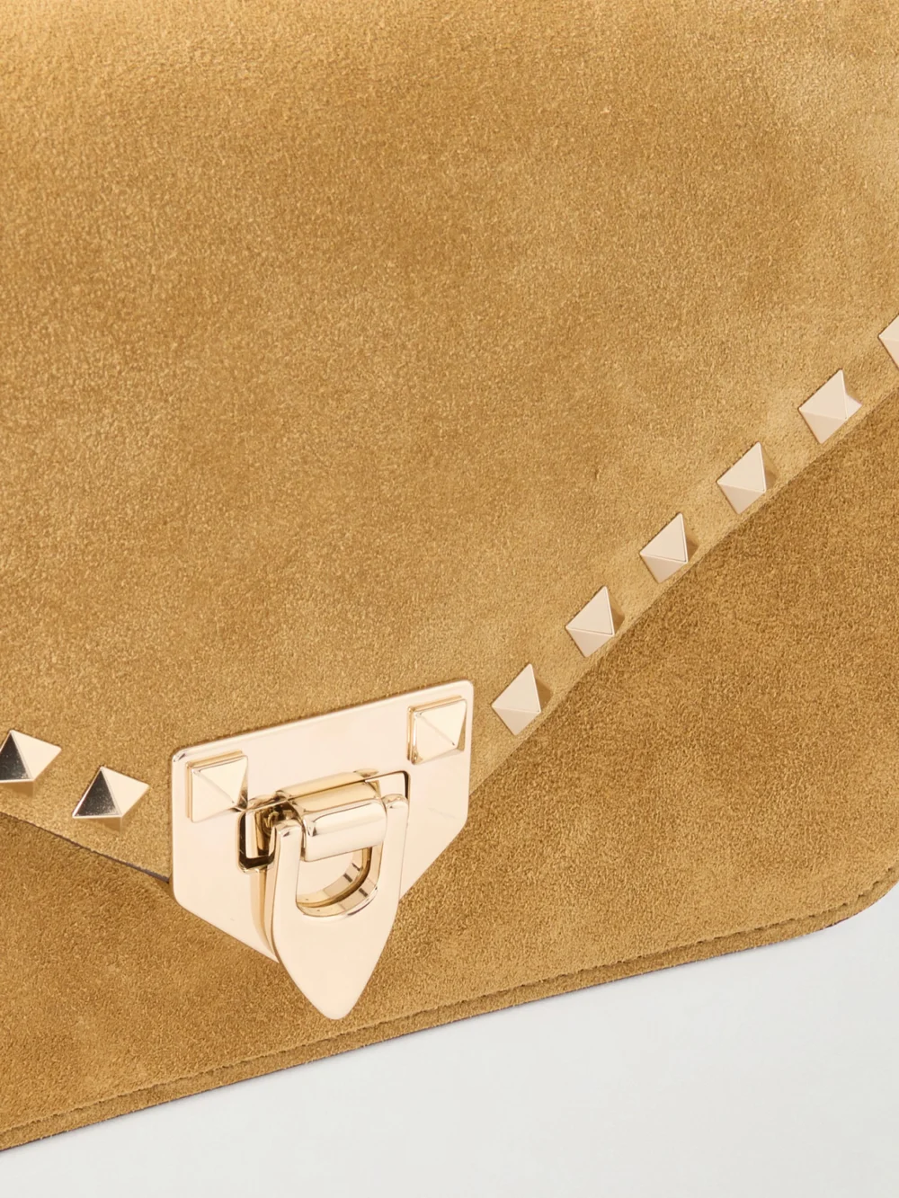 Close-up detail of the Valentino Garavani Rockstud Embellished Suede Shoulder Bag