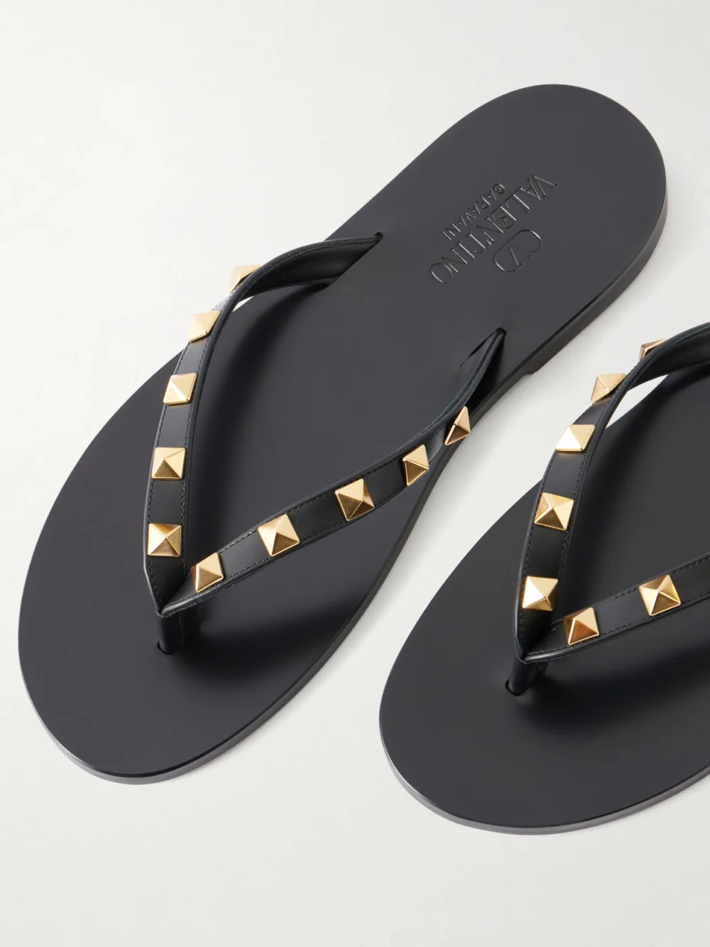 Close-up detail of the Valentino Garavani Rockstud Leather Thong Sandals