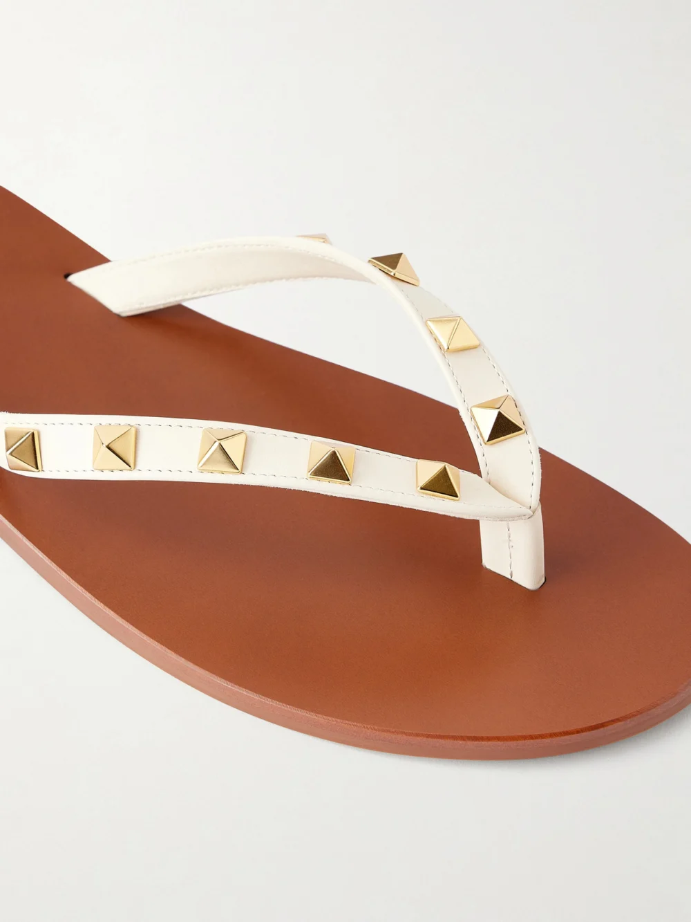 Close-up detail of the Valentino Garavani Rockstud Leather Thong Sandals