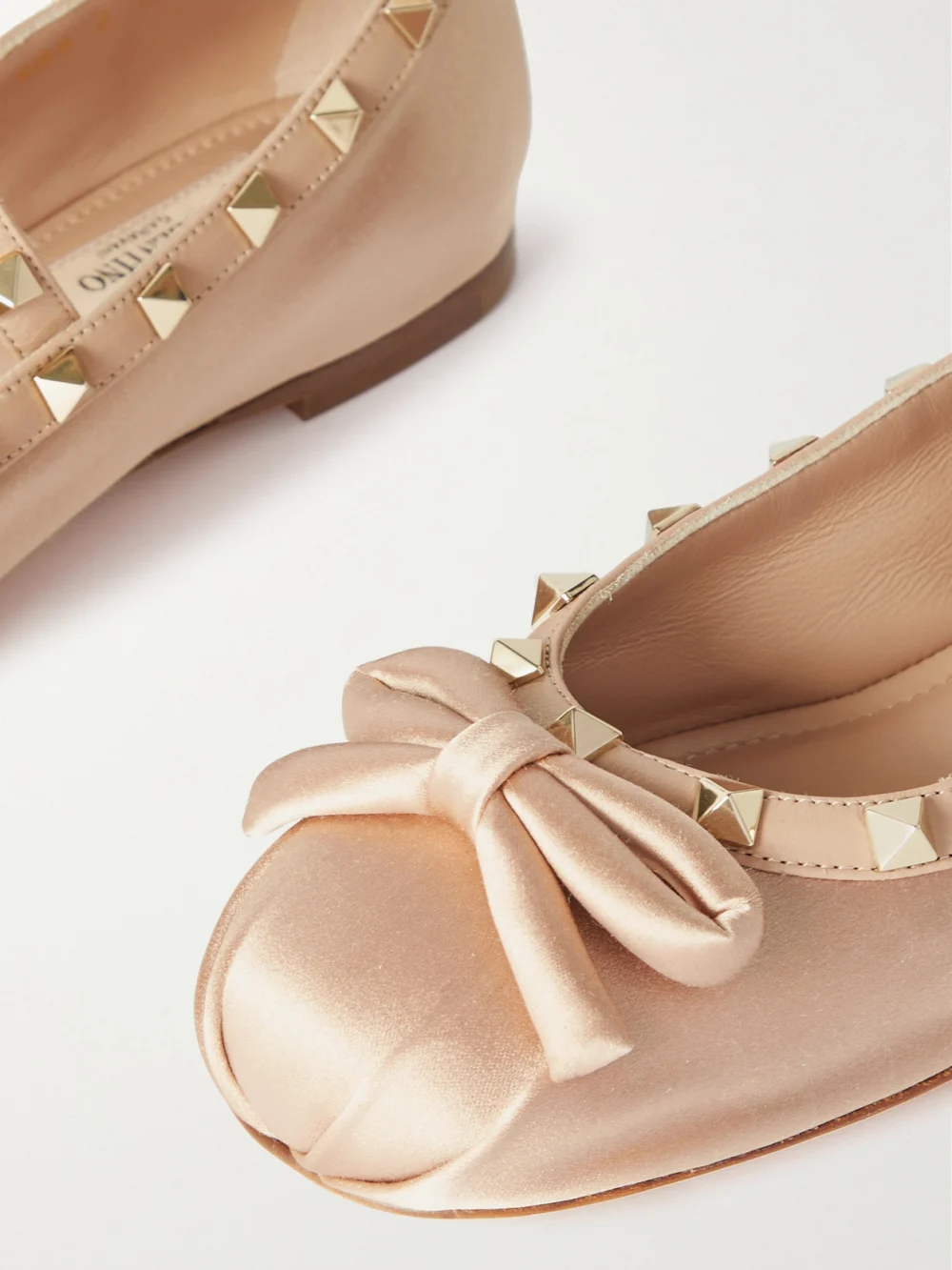 Close-up detail of the Valentino Garavani Rockstud Leather-trimmed Satin Ballet Flats