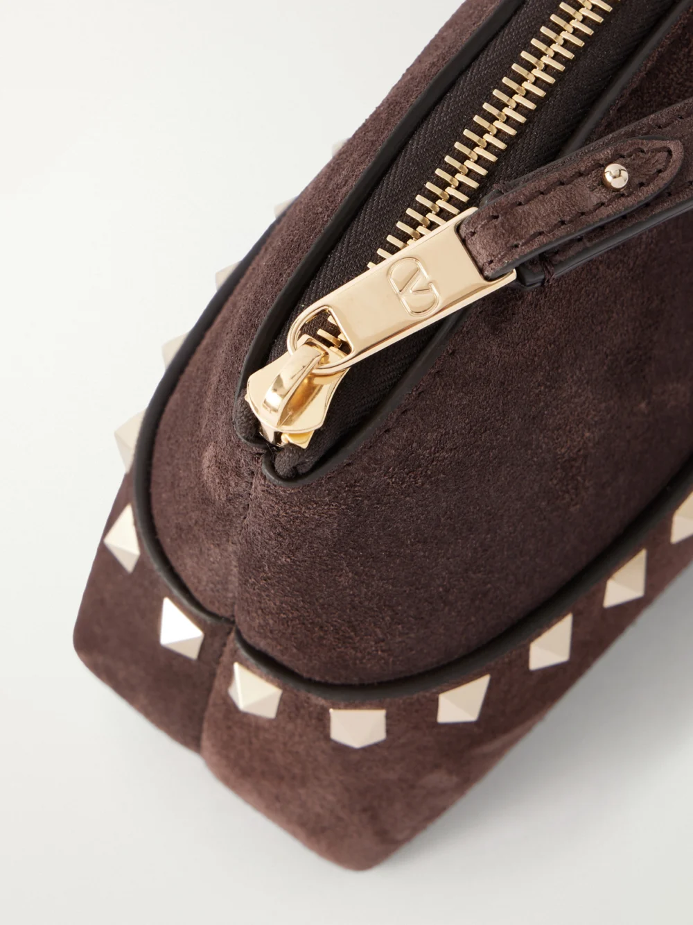 Close-up detail of the Valentino Garavani Rockstud Suede Clutch
