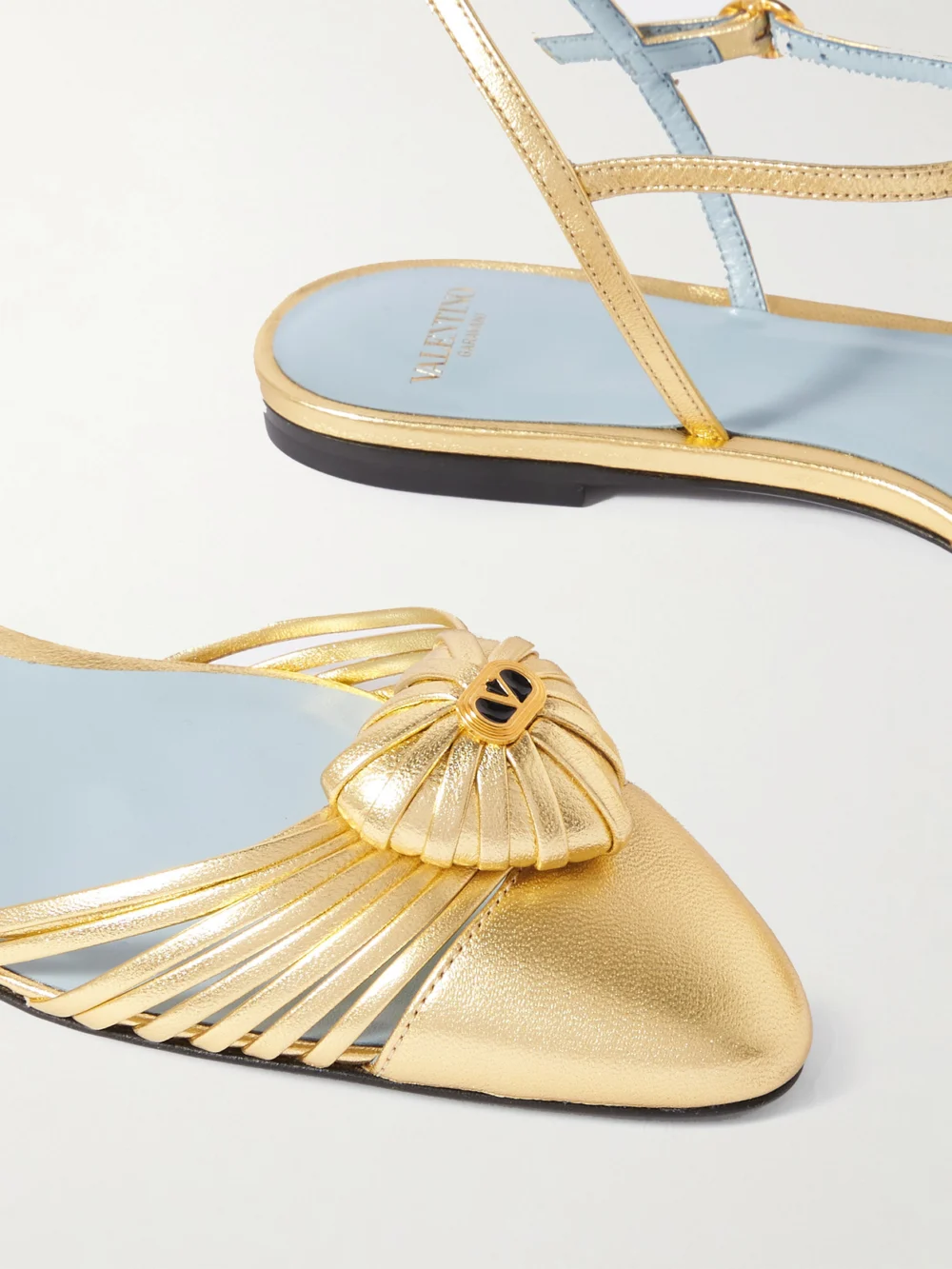 Close-up detail of the Valentino Garavani Royal Vlogo Embellished Metallic Leather Slingback Flats