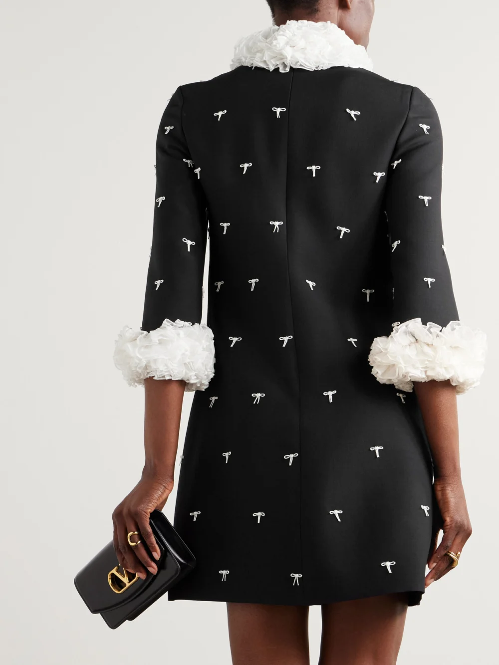Back view of the Valentino Garavani Ruffled Bow-detailed Embellished Mesh-trimmed Wool and Silk-blend Crepe Mini Dress