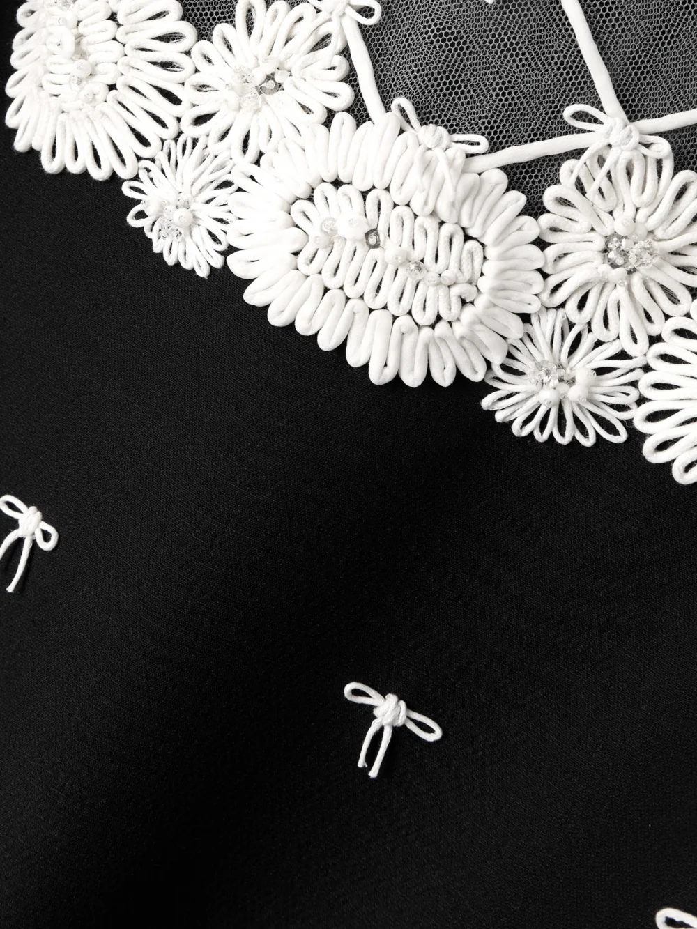 Close-up detail of the Valentino Garavani Ruffled Bow-detailed Embellished Mesh-trimmed Wool and Silk-blend Crepe Mini Dress