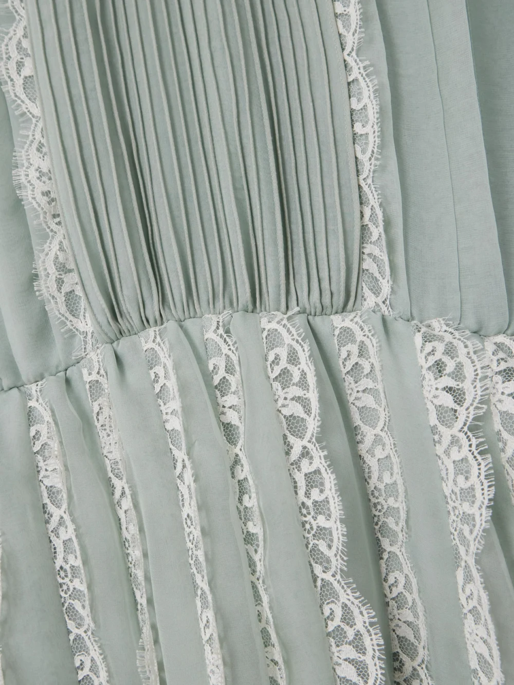 Close-up detail of the Valentino Garavani Ruffled Lace-trimmed Pleated Silk-chiffon Gown
