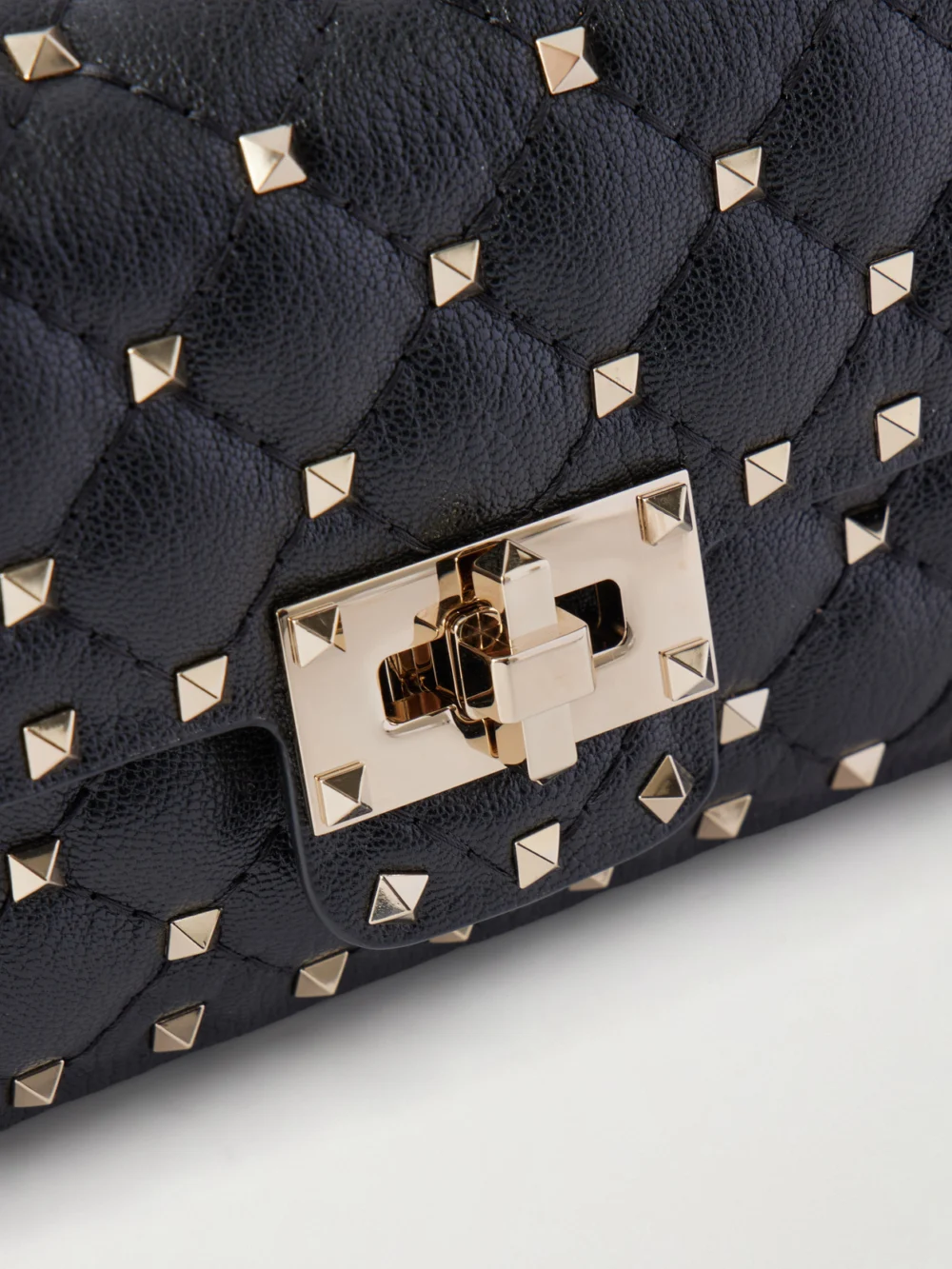 Close-up detail of the Valentino Garavani Spike Small Studded Quilted Leather Shoulder Bag