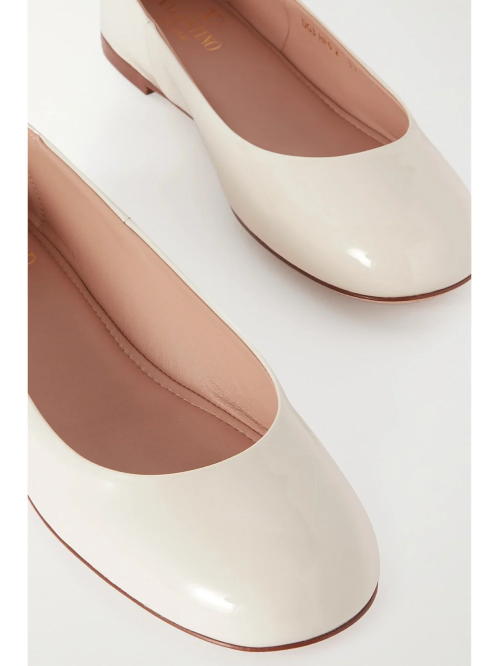 Close-up detail of the Valentino Garavani Tan-go Patent-leather Ballet Flats