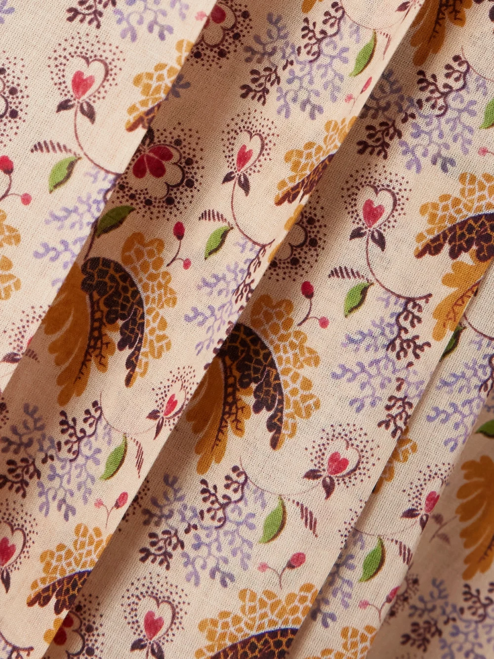 Close-up detail of the Valentino Garavani Tie-neck Belted Pleated Floral-print Cotton-muslin Blouse