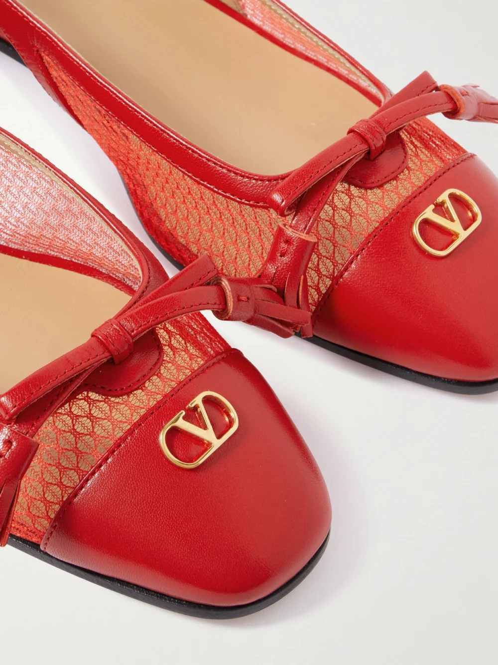 Close-up detail of the Valentino Garavani Valet Du Roi 25 Tasseled Leather and Mesh Slingback Ballet Flats