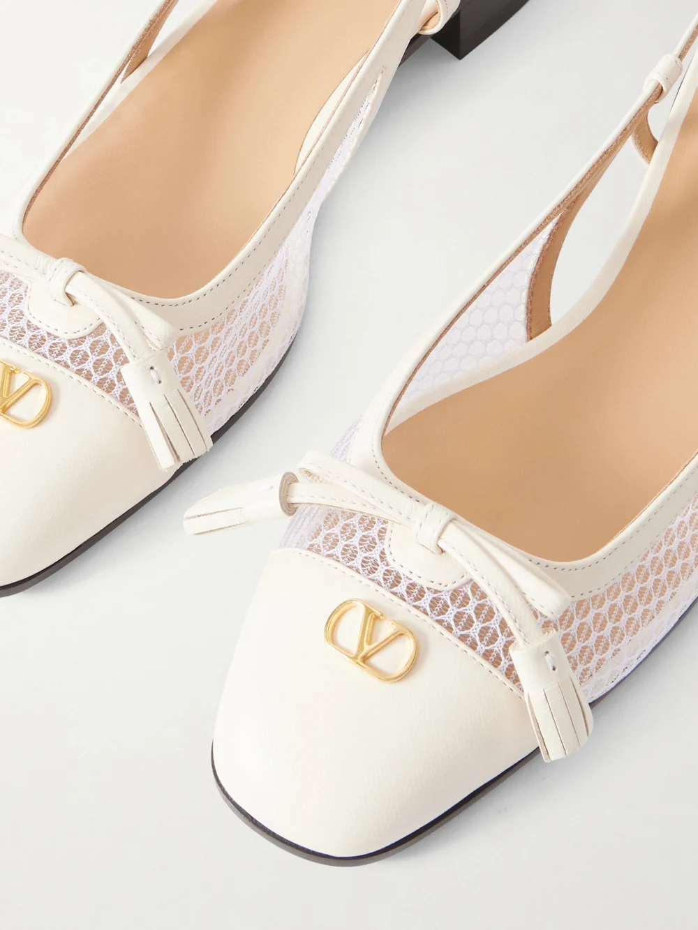 Close-up detail of the Valentino Garavani Valet Du Roi 25 Tasseled Leather and Mesh Slingback Ballet Flats