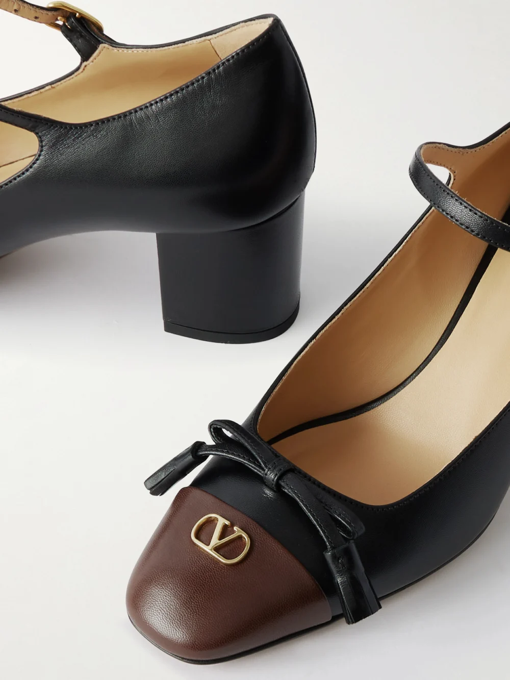 Close-up detail of the Valentino Garavani Valet Du Roi 60 Tasseled Two-tone Leather Mary Jane Pumps
