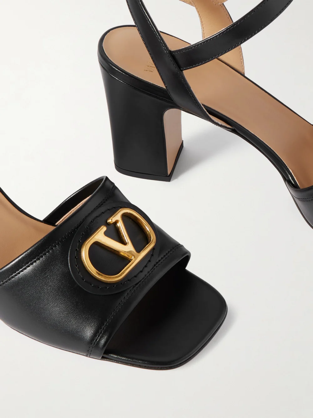 Close-up detail of the Valentino Garavani Vlogo 75 Embellished Leather Sandals