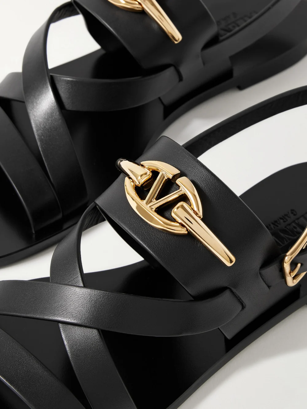 Close-up detail of the Valentino Garavani Vlogo Embellished Leather Sandals