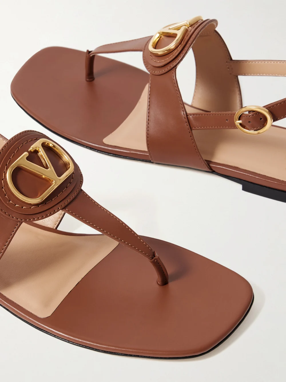 Close-up detail of the Valentino Garavani Vlogo Embellished Leather Sandals