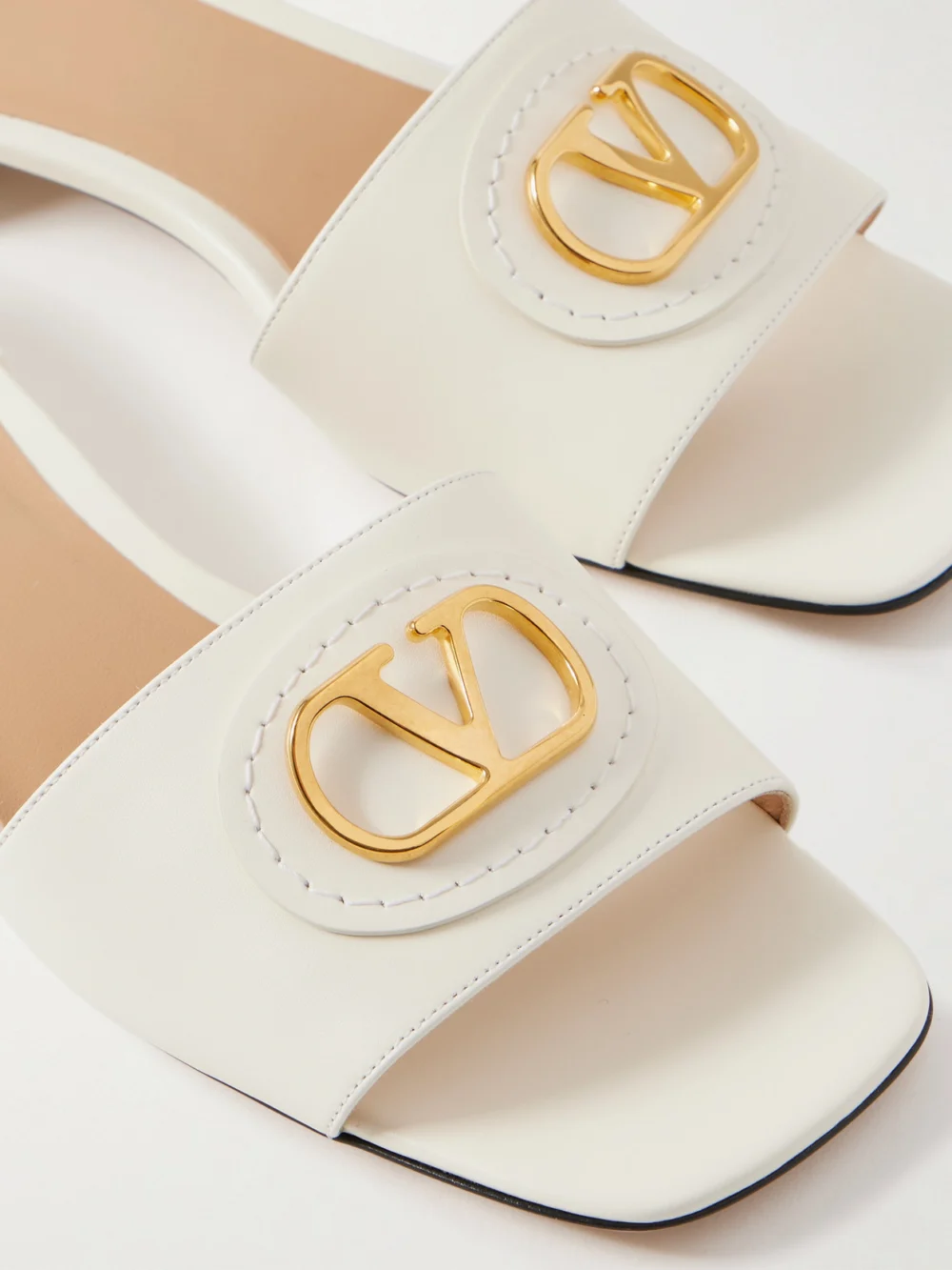 Close-up detail of the Valentino Garavani Vlogo Embellished Leather Slides