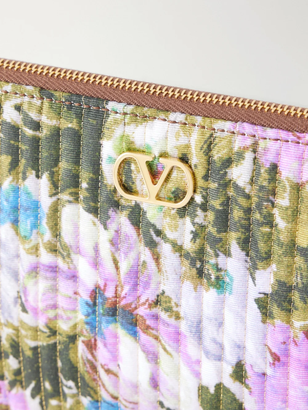 Close-up detail of the Valentino Garavani Vlogo-embellished Medium Leather-trimmed Quilted Floral-jacquard Clutch