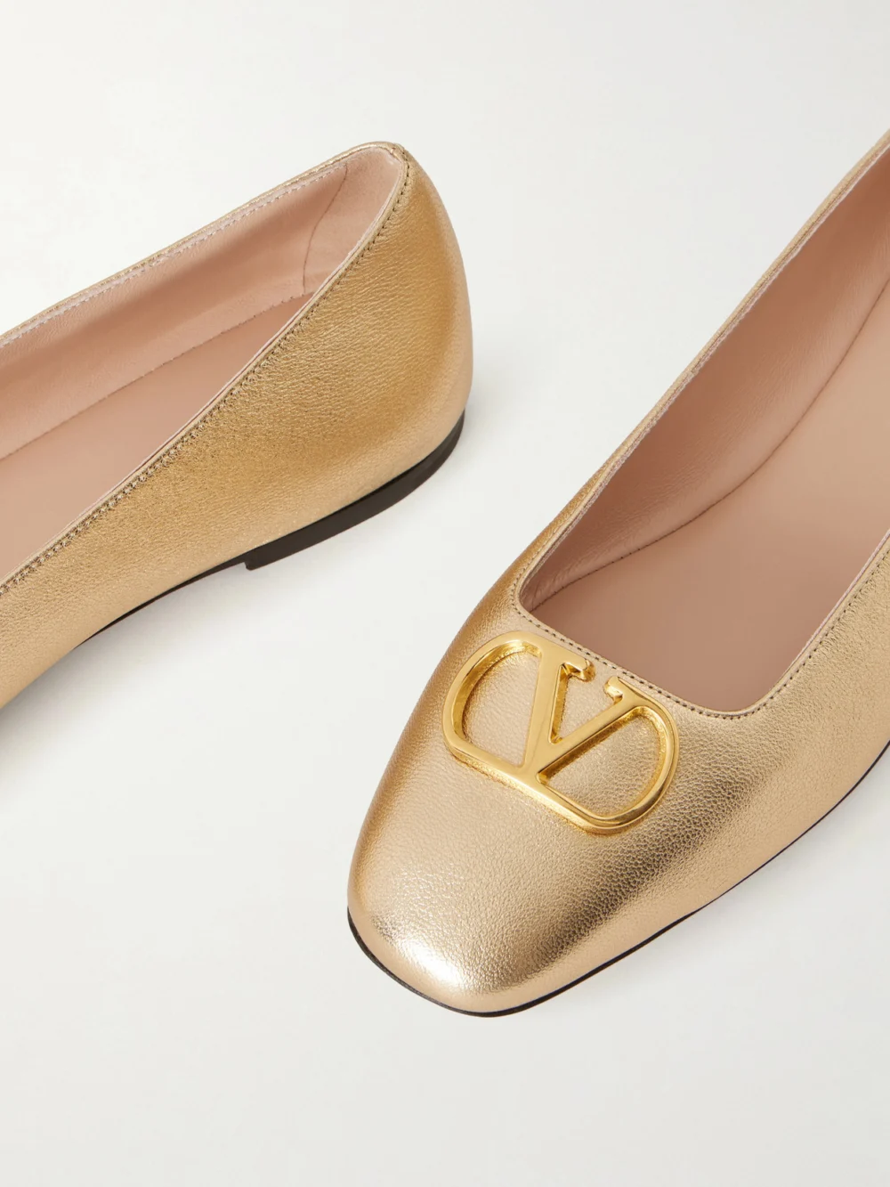 Close-up detail of the Valentino Garavani Vlogo Embellished Metallic Leather Ballet Flats
