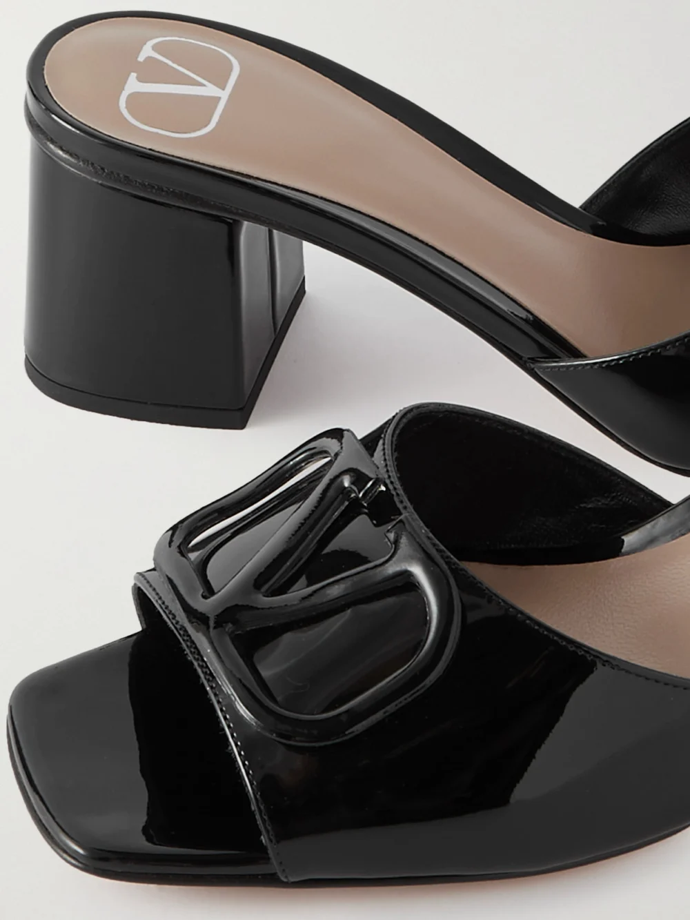 Close-up detail of the Valentino Garavani Vlogo Embellished Patent-leather Mules