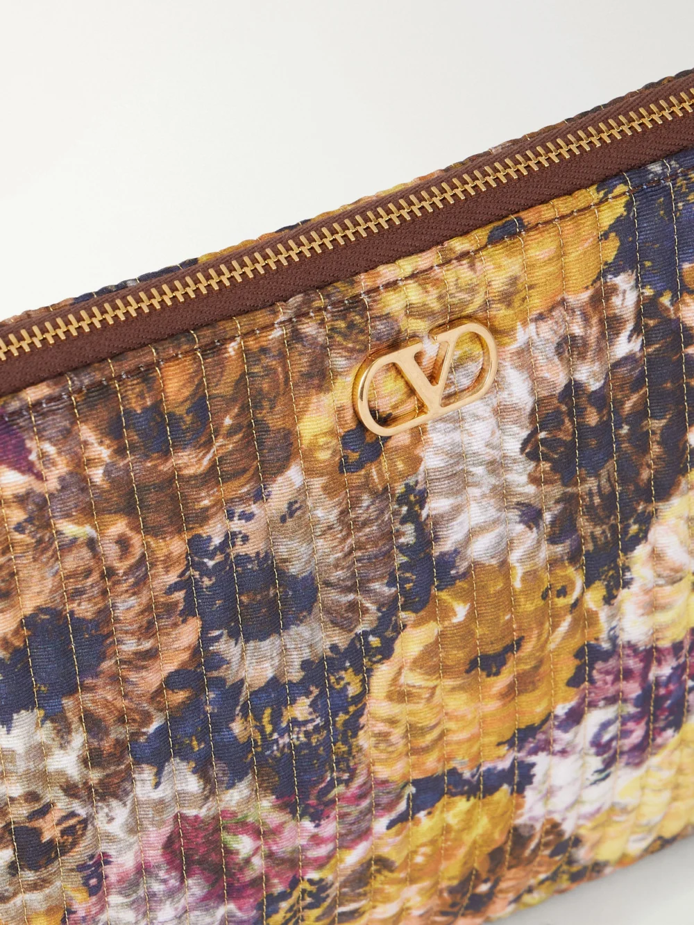 Close-up detail of the Valentino Garavani Vlogo Floral-print Moire Clutch