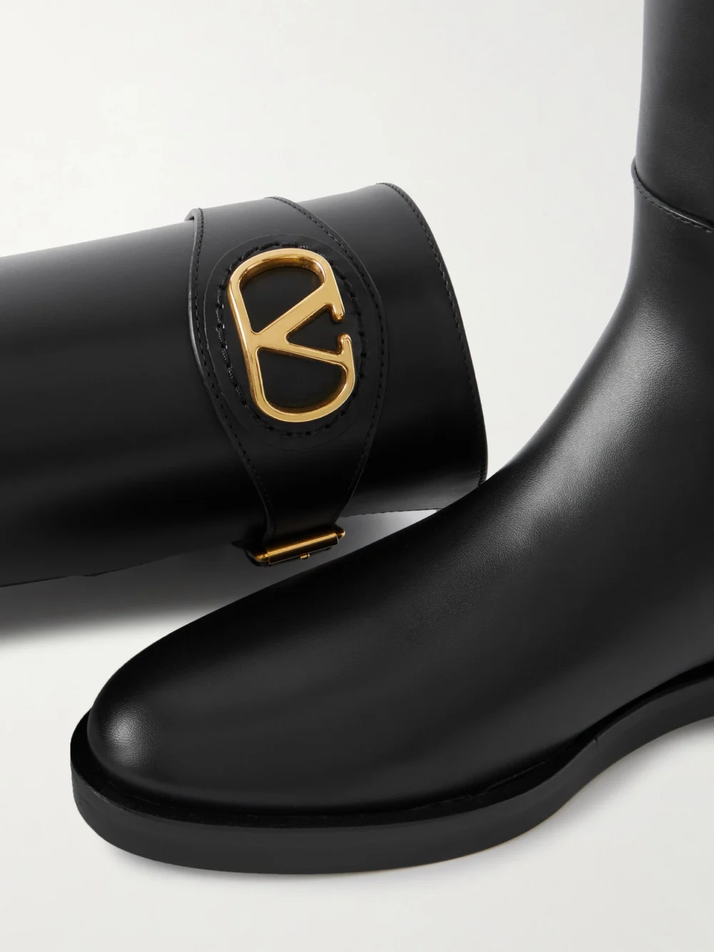 Close-up detail of the Valentino Garavani Vlogo Leather Knee Boots