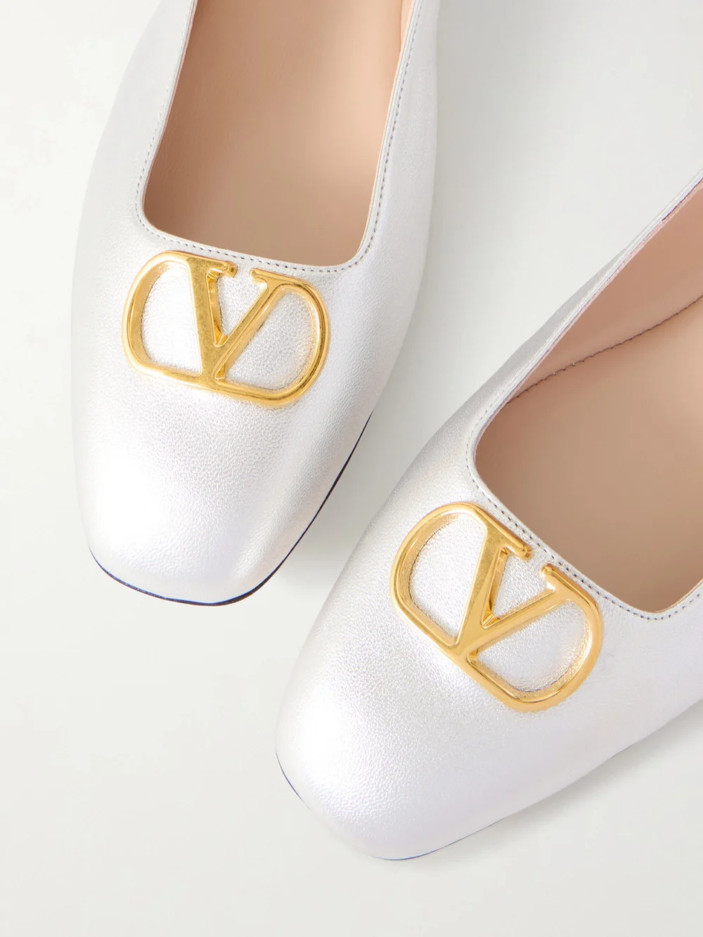 Close-up detail of the Valentino Garavani Vlogo Metallic Leather Ballet Flats