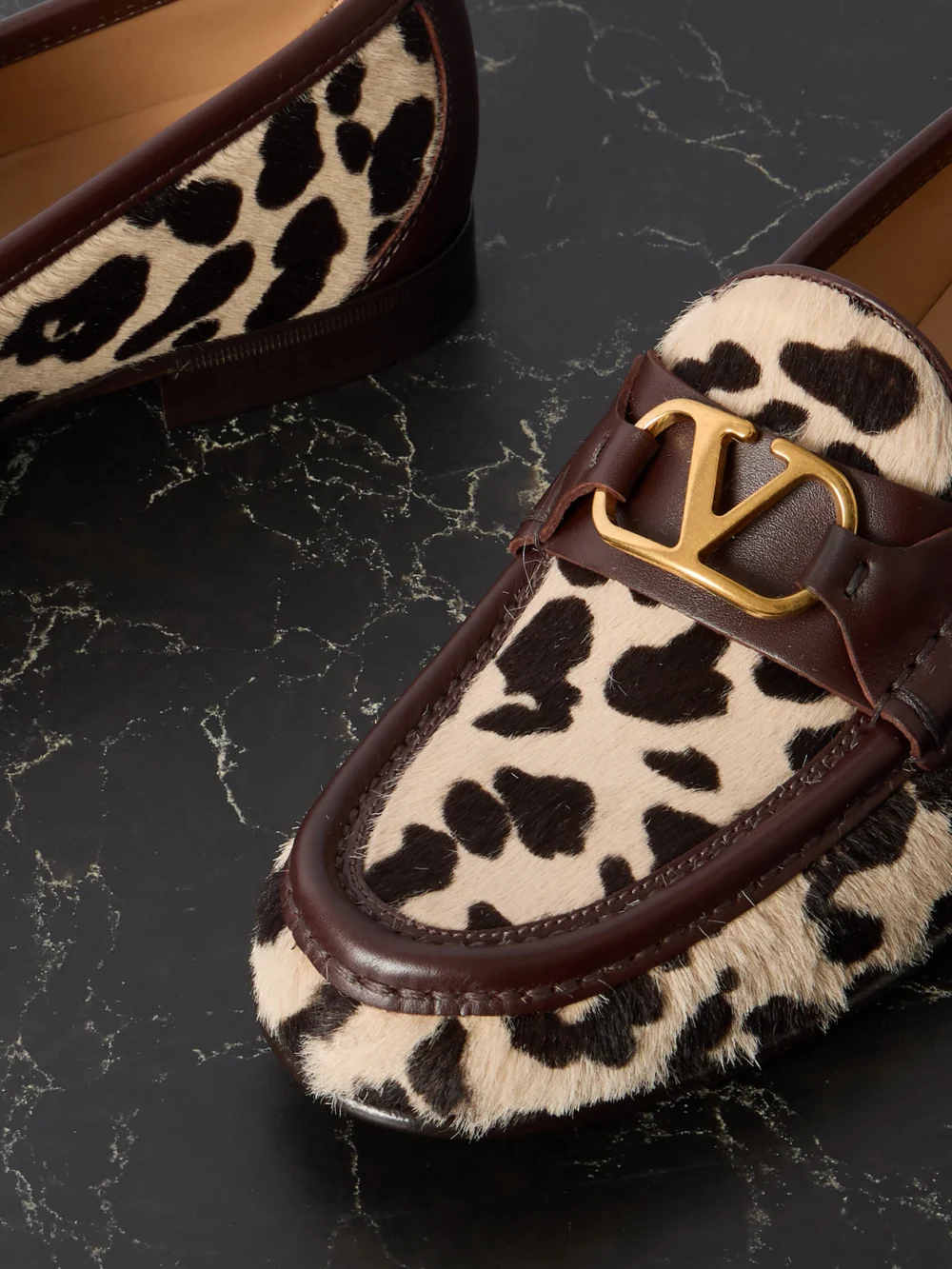Close-up detail of the Valentino Garavani Vlogo Signature 20 Leather-trimmed Leopard-print Calf Hair Loafers