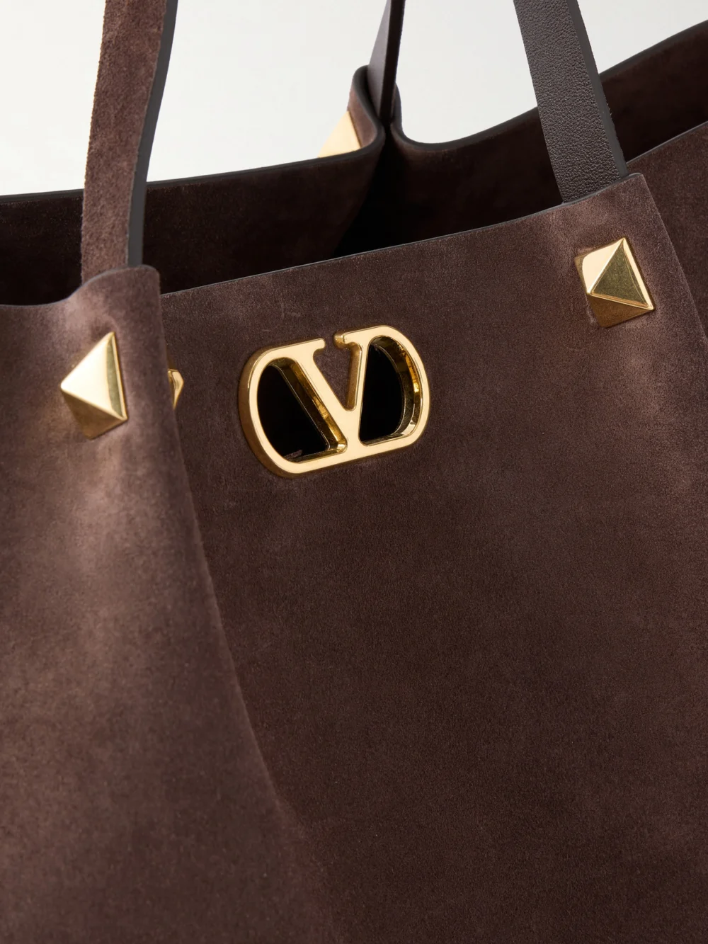 Close-up detail of the Valentino Garavani Vlogo Signature Studded Suede Tote