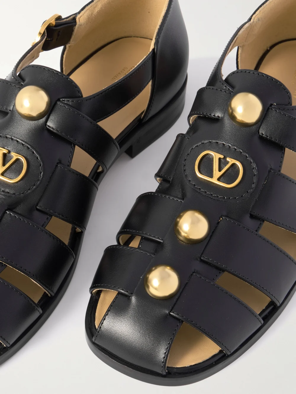 Close-up detail of the Valentino Garavani Vlogo Stud-embellished Leather Sandals