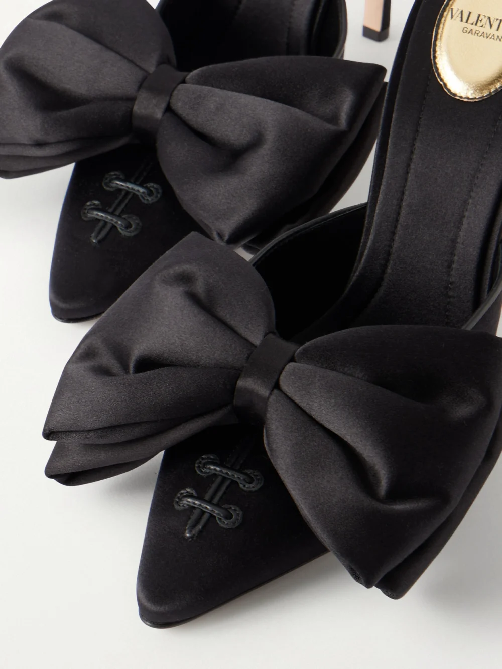 Close-up detail of the Valentino Garavani Yolande 105 Bow-embellished Satin Mules