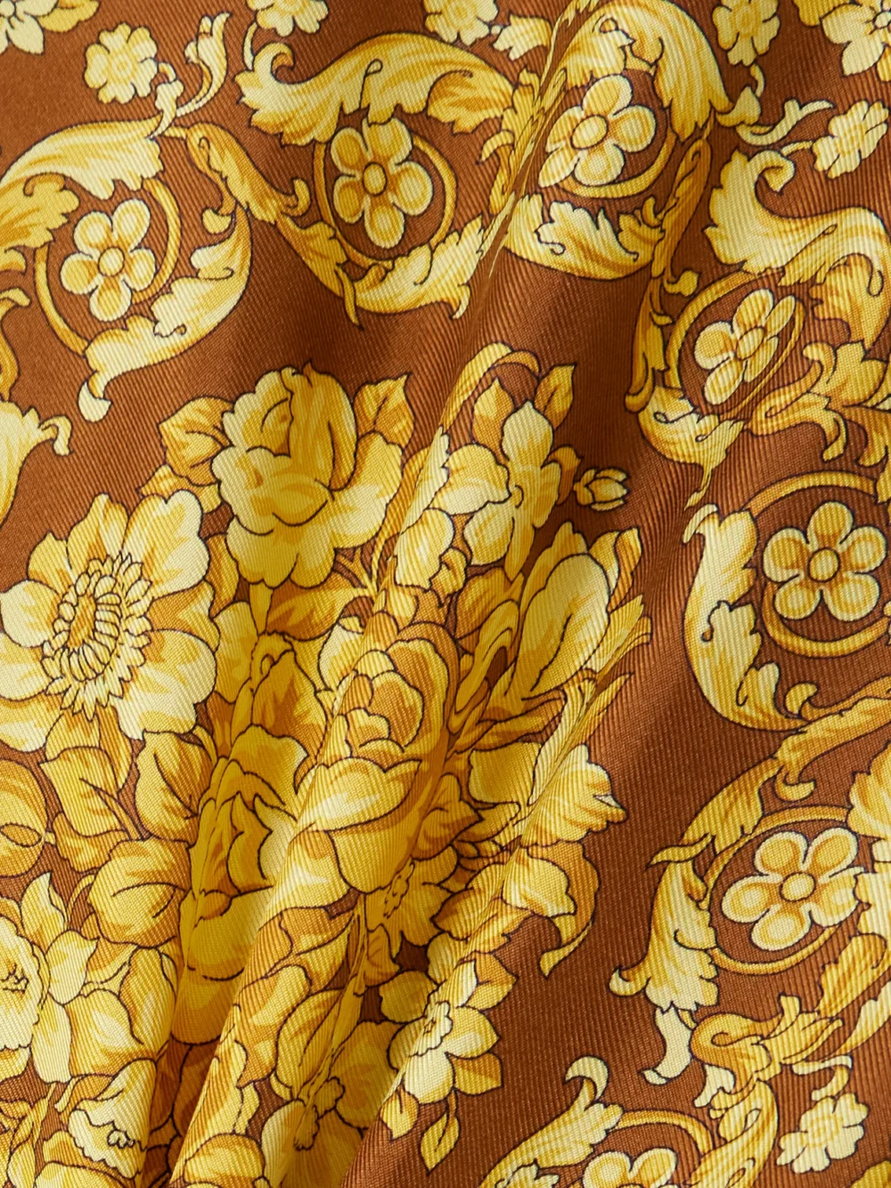 Close-up detail of the Versace Belted Printed Silk-twill Mini Dress