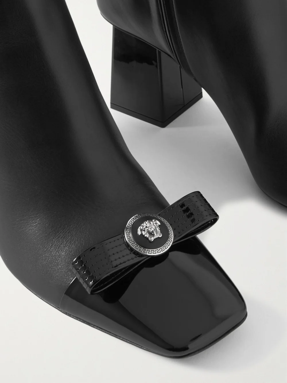 Close-up detail of the Versace Bow-embellished Leather Ankle Boots