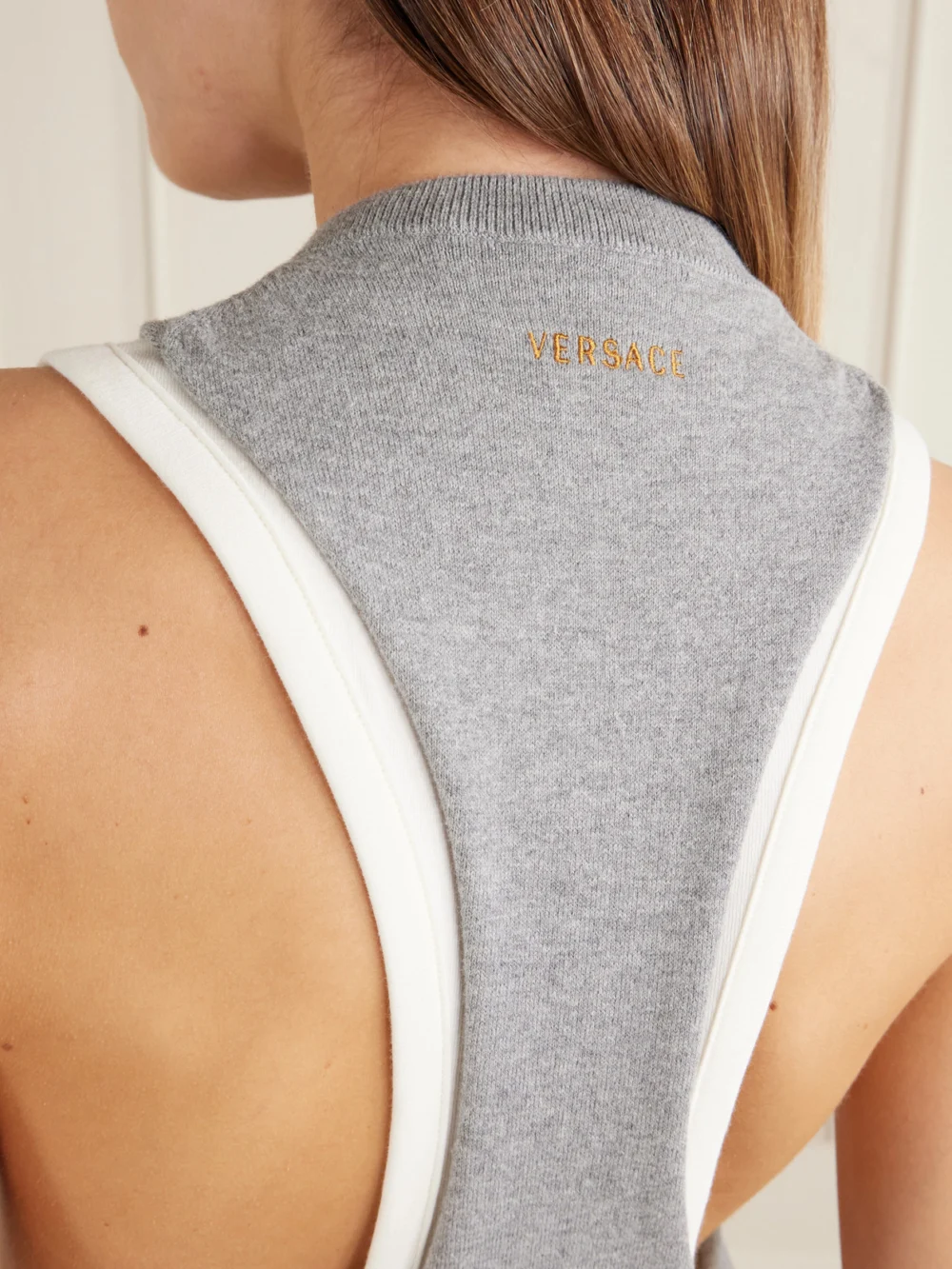 Close-up detail of the Versace Cut-out Knitted Cotton Vest