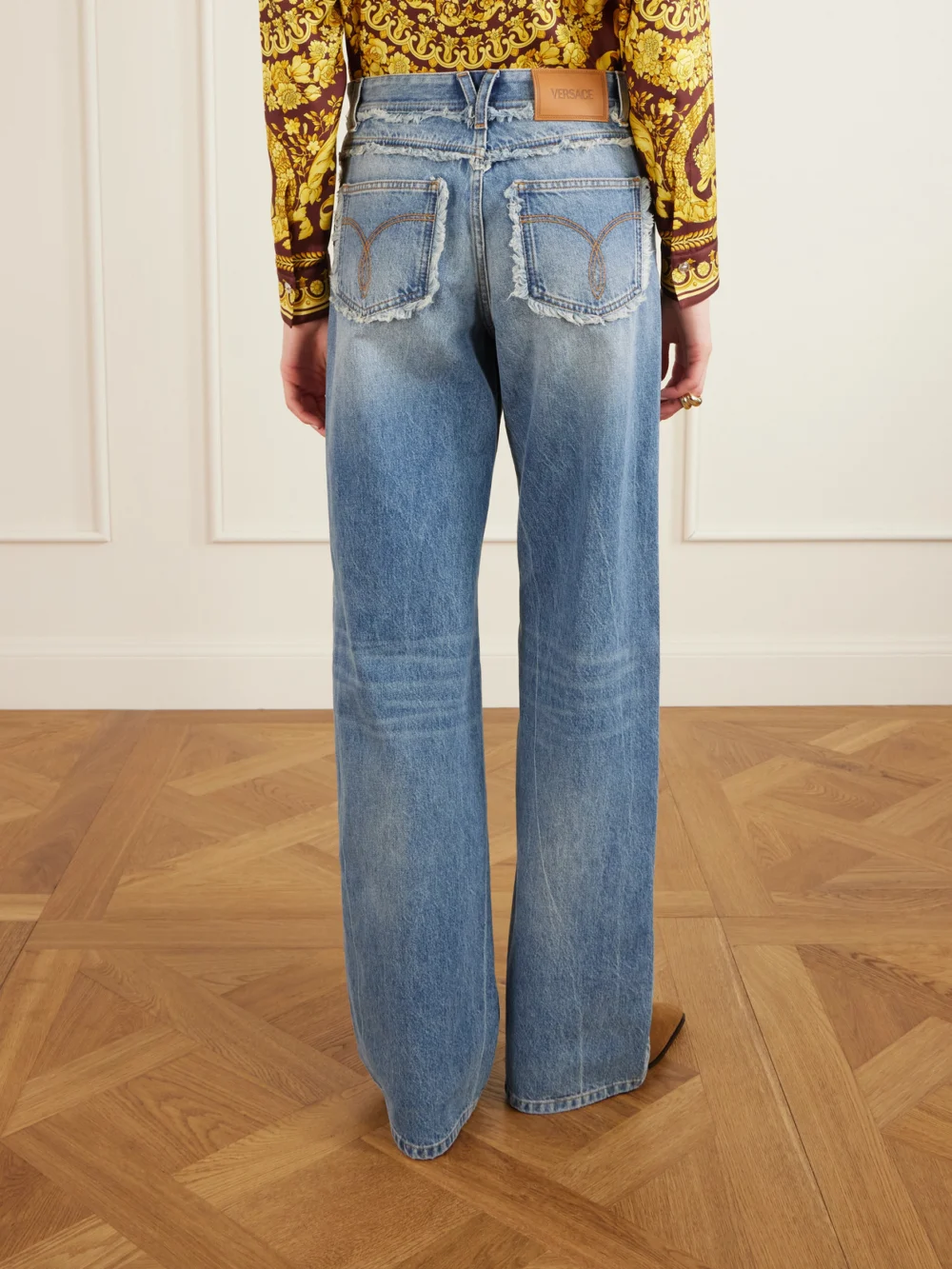 Back view of the Versace Distressed Mid-rise Straight-leg Jeans