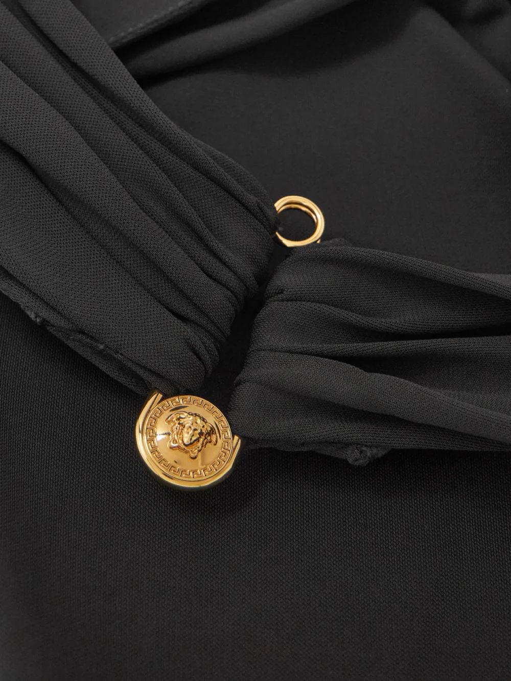 Close-up detail of the Versace Embellished Draped Stretch-jersey Halterneck Dress